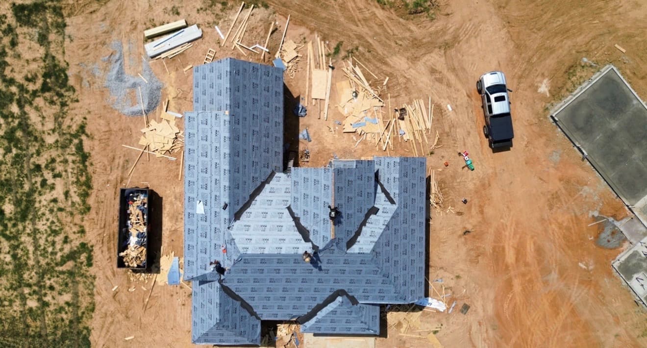 Overhead drone view of a Mid-South roof fully covered in synthetic underlayment by Precision Roofing